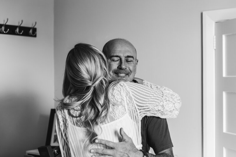 black and white image of bride hugging her dad