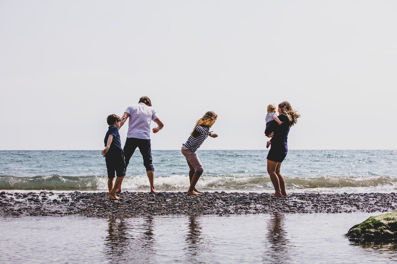 A family playing on the beach captured by Devon Wedding Photographer