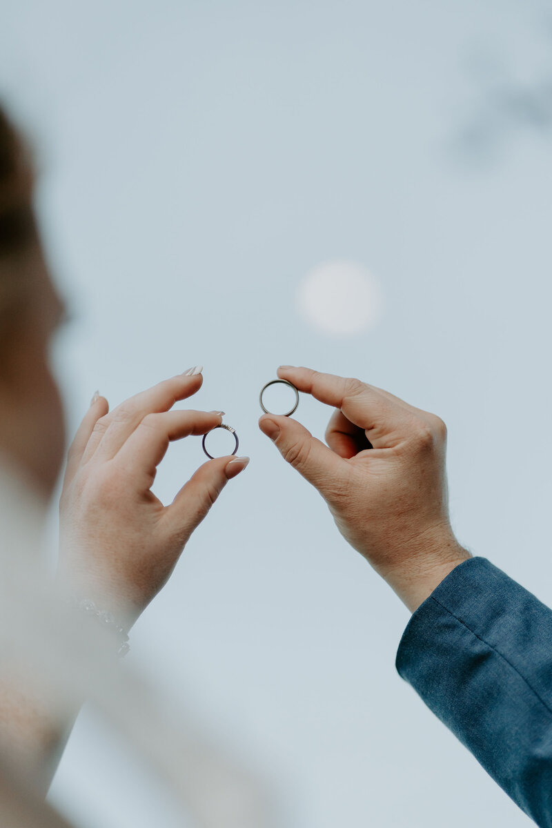 White and green flower arrangements styled on rectangle white plinths