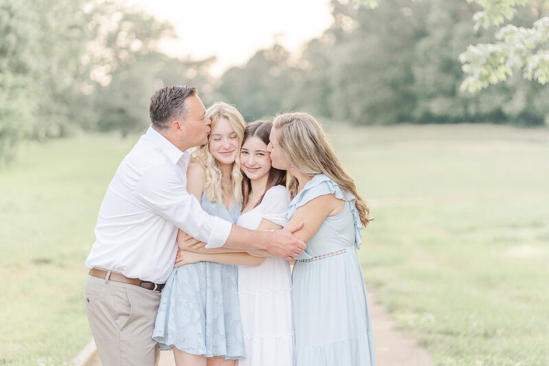 parents kissing teenage kids taken by Fairfax County, Virginia spring mini session photographer