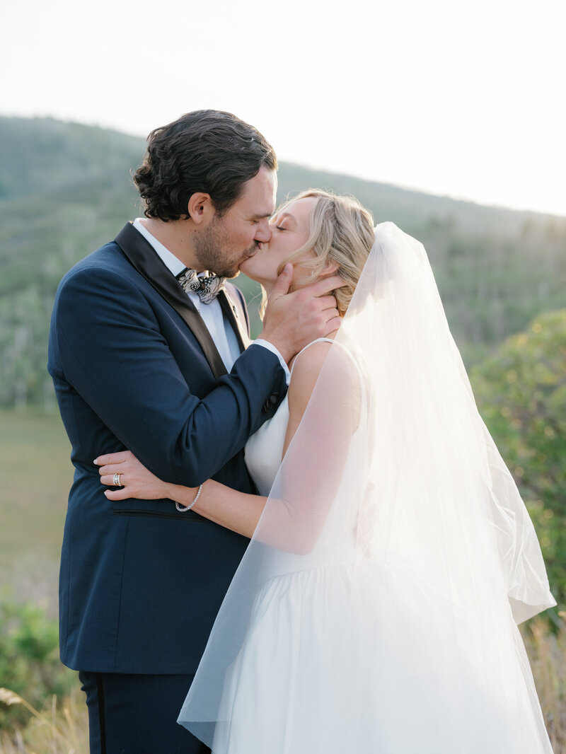 Bride and groom kiss, photographed by Aspen Wedding Photographers Sarah Nann