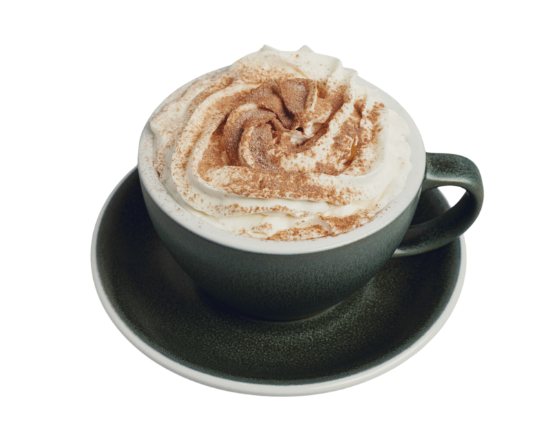 Green ceramic cup filled with specialty coffee, topped with whipped cream and cocoa powder, served at Lyla's House in Georgetown, ON.