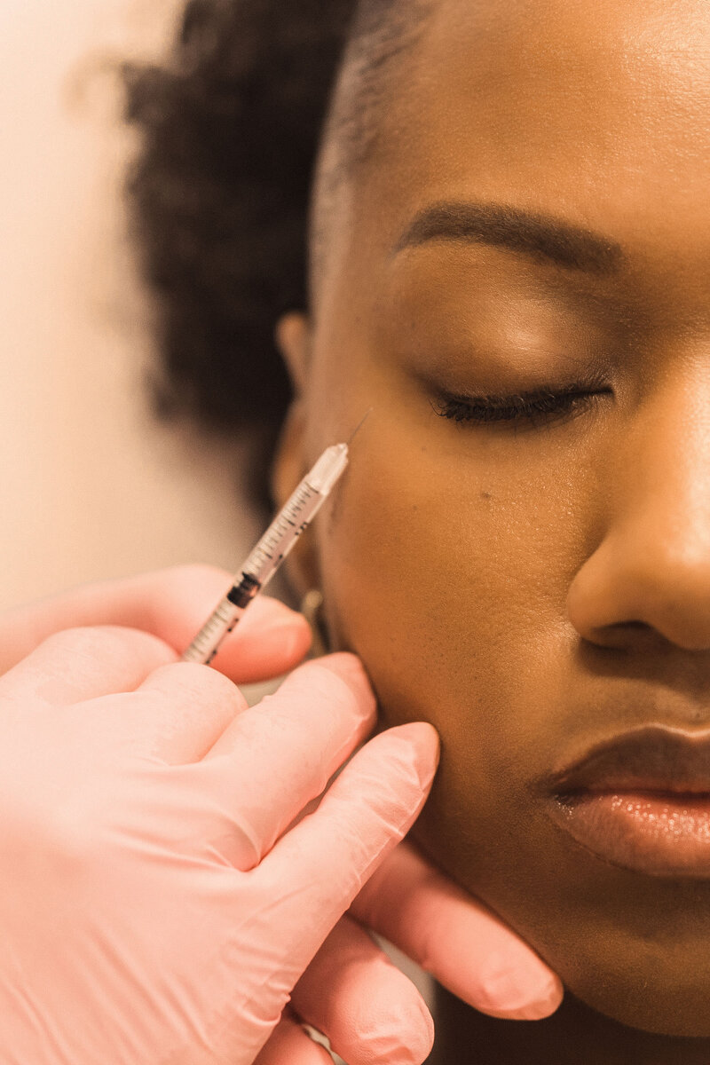 woman receiving a cosmetic injection in her face