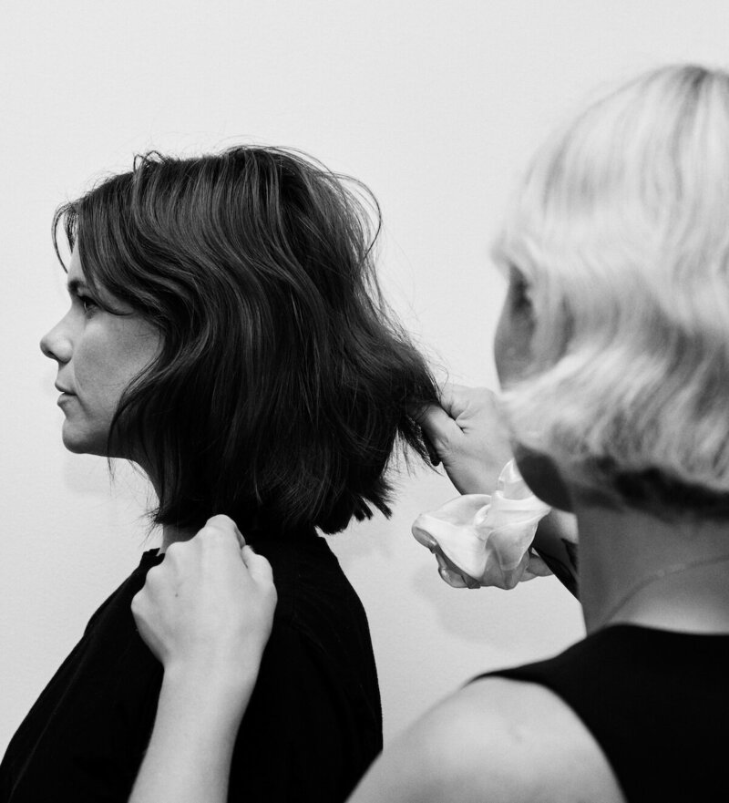 Hannah Hewitt consulting with client, reading texture and growth patterns before an intuitive haircut.