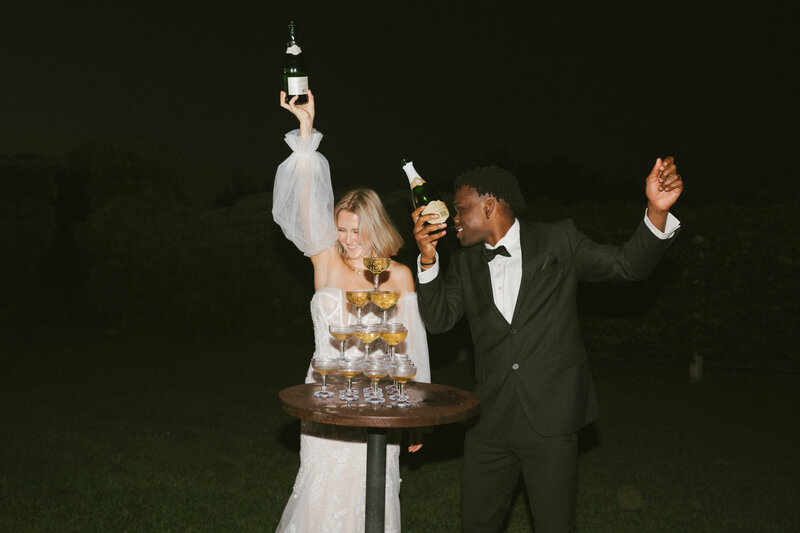 bride and groom celebrating with a champagne tower