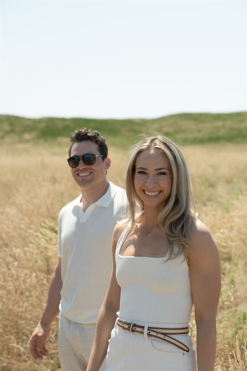 Engaged couple in field for their engagement photoshoot 