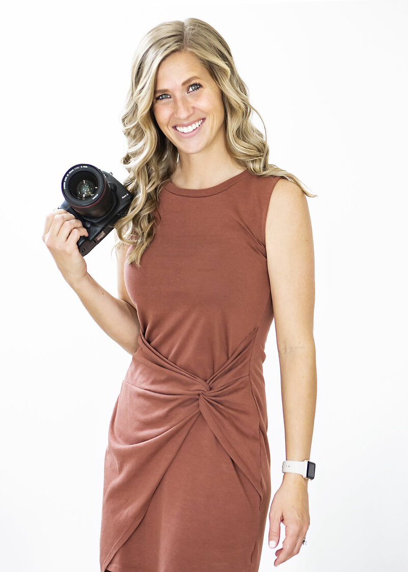 Portrait of Ashley Beaman holding her camera