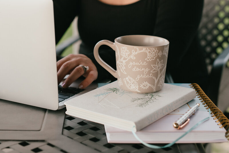 coffee cup sitting on stack of books