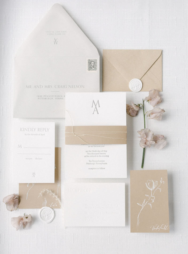 White linen styling mat with vow books and wedding rings for bridal flat lay