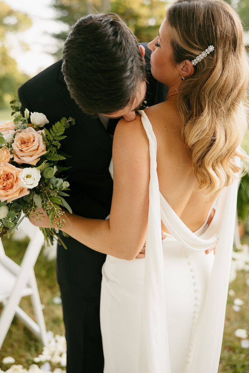Groom kissing bride at warm, vibrant Nashville wedding