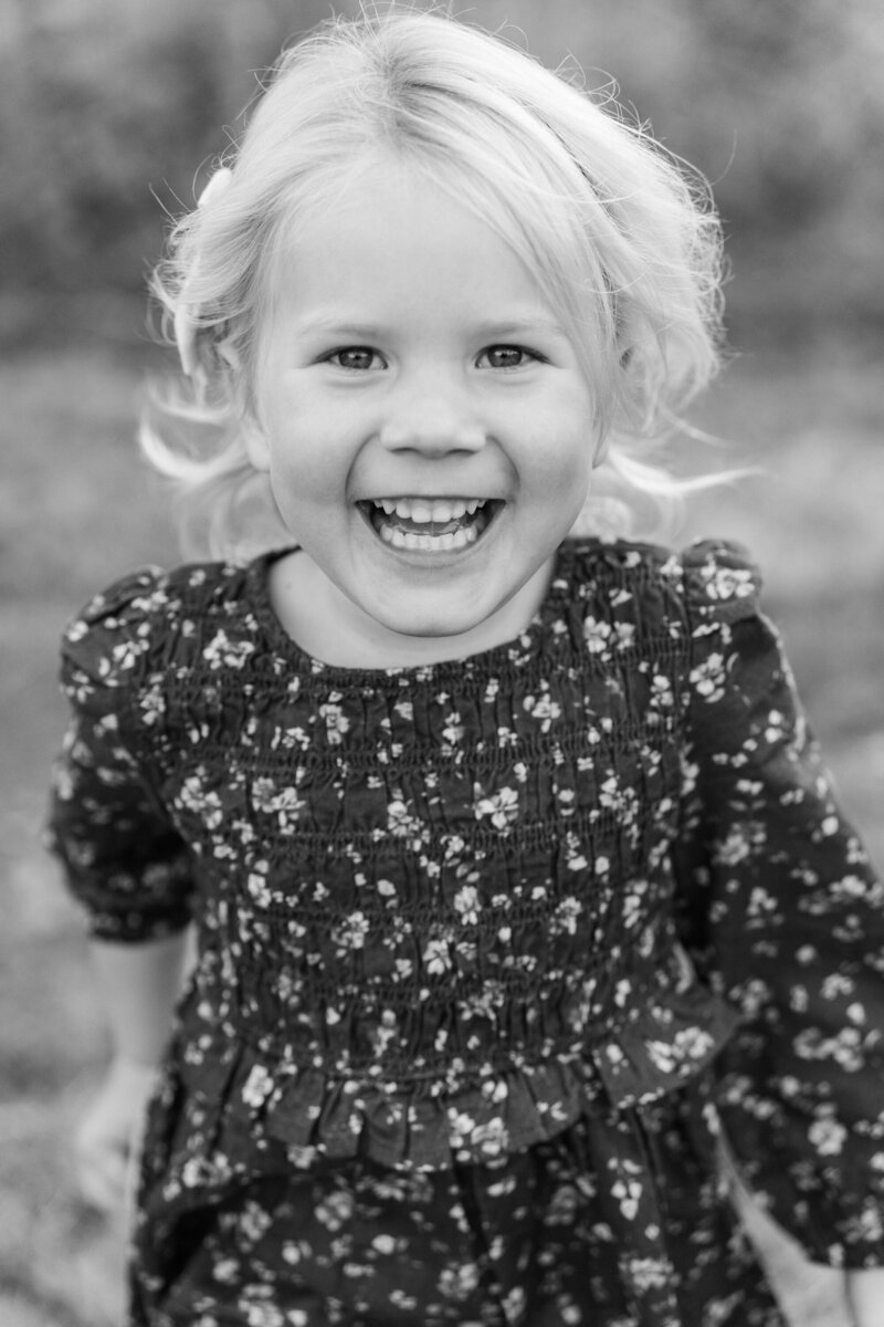 child laughing in a classic black and white photo by minnesota family photographer Ashley Yantes