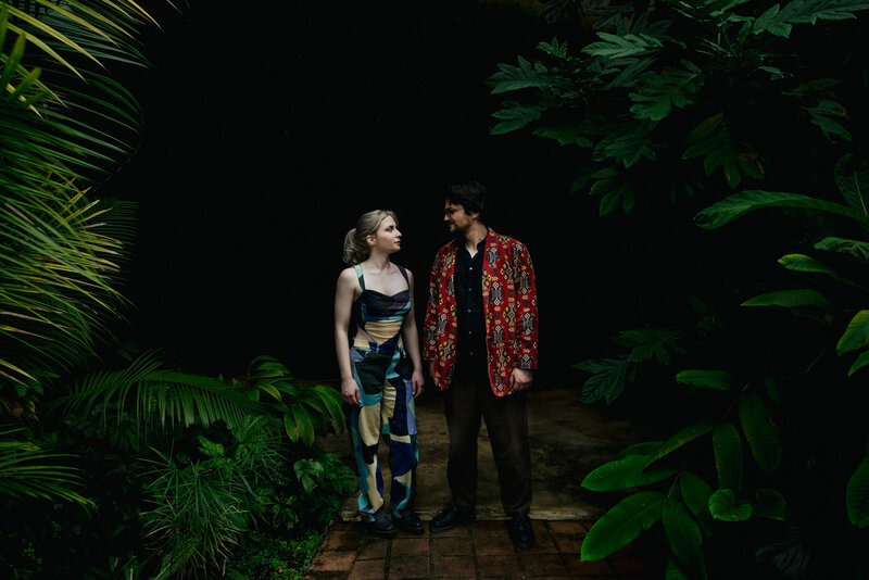 Hipster Couple standing in Botanical Garden Greenhouse
