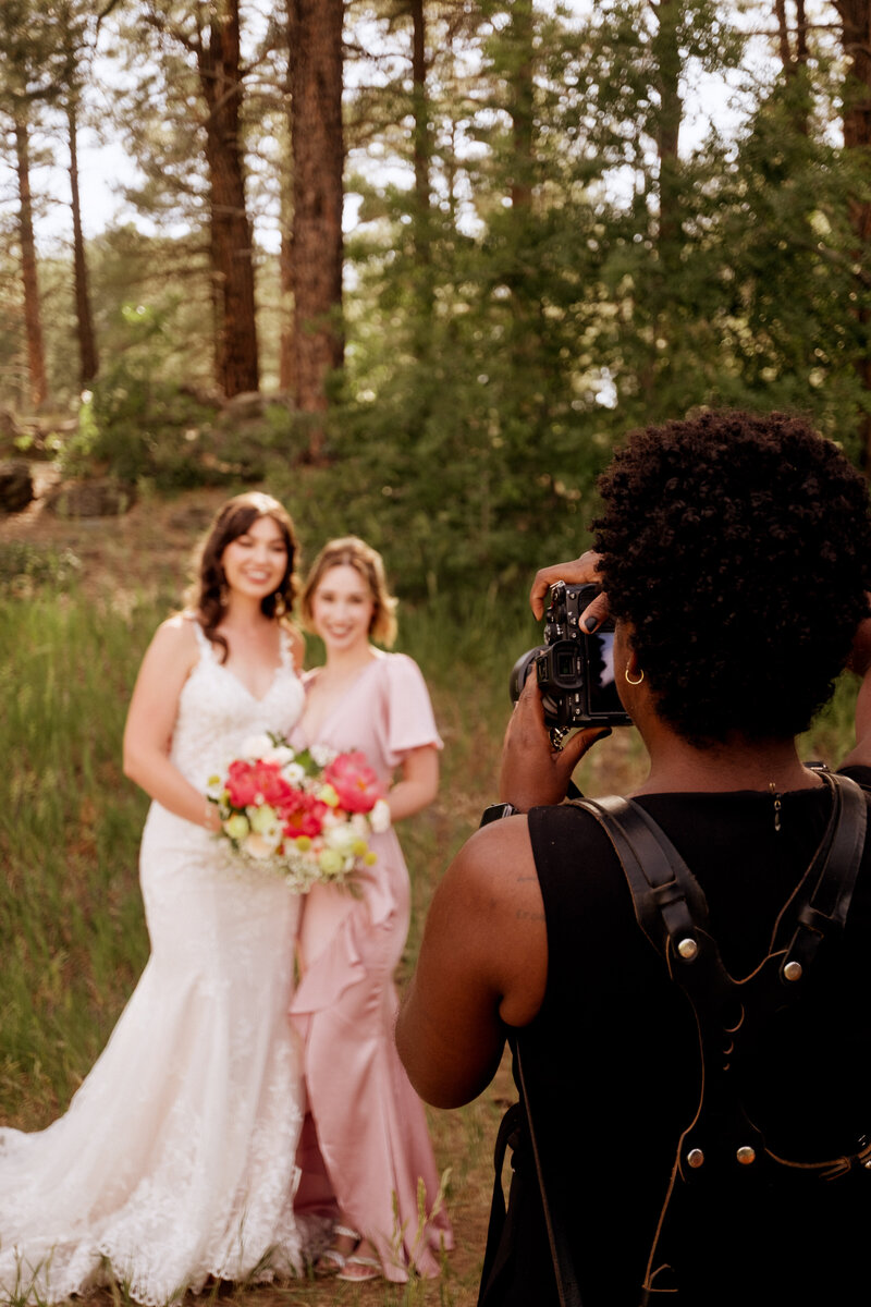 A photographer taking pictures of a wedding couple.