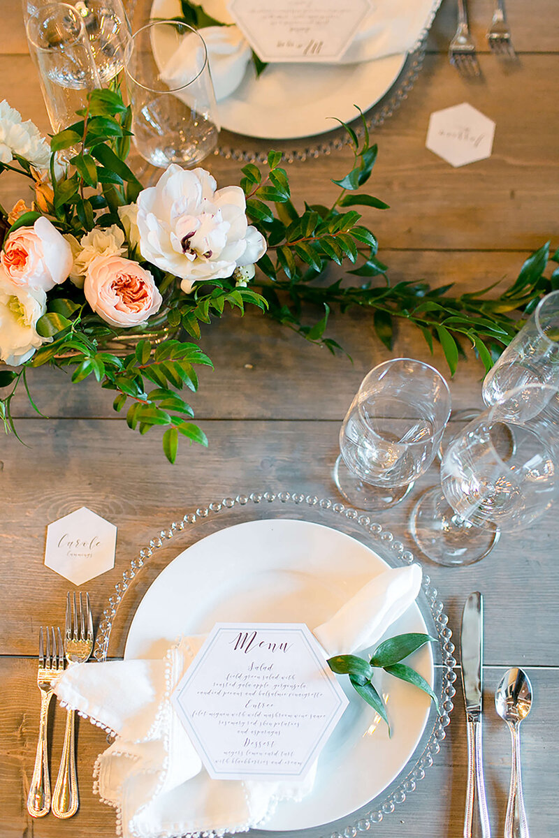 Elegant equestrian ranch wedding reception with  hexagon menu card at each place setting.