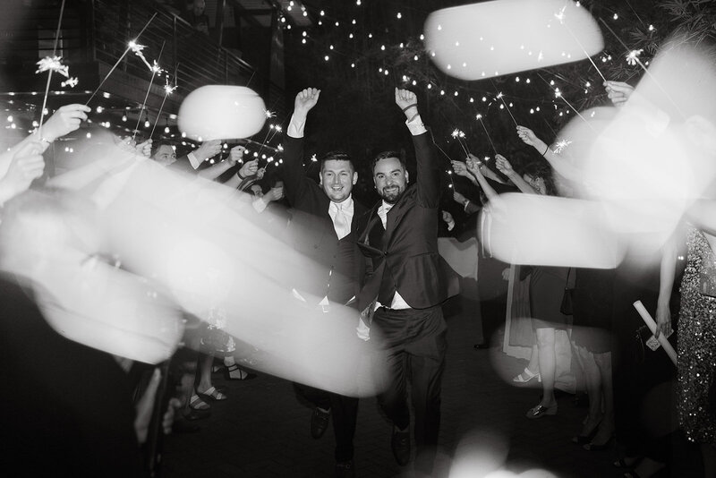 grooms cheering sparkler exit wedding
