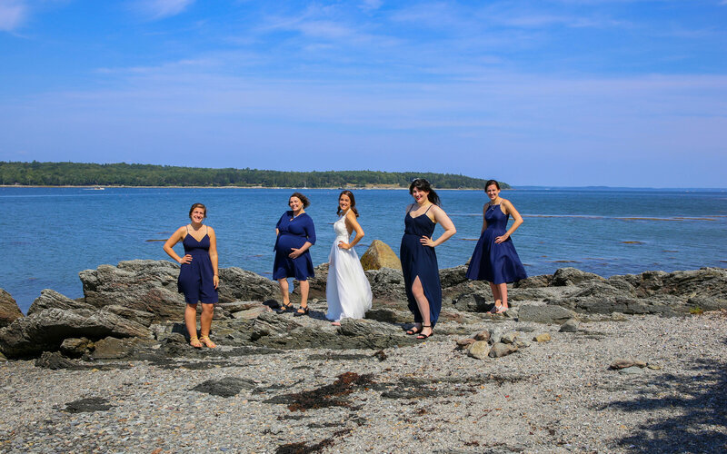 Bride and Bridesmaids standing on beach together | Bar Harbor, Maine Wedding Photography