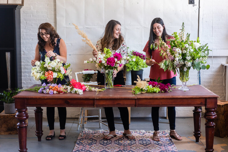 women putting together flower arrangements