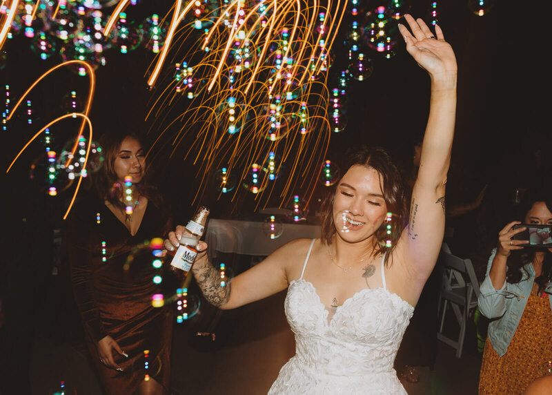 Bride dancing during reception with cool light shutter drag