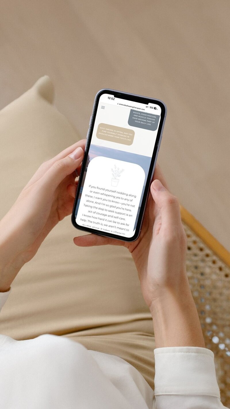  Woman texting on her iPhone, focused on a therapists new Showit website.