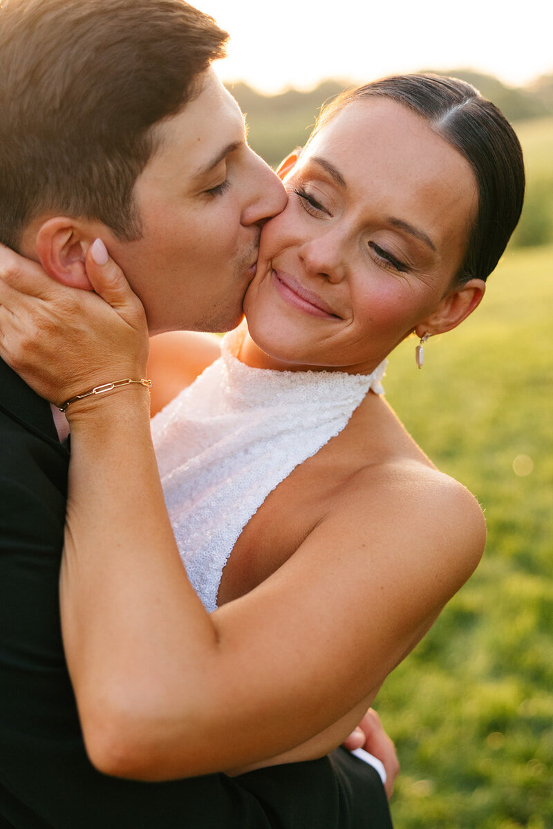 Warm, vibrant photo of groom kissing bride on Nashville wedding day