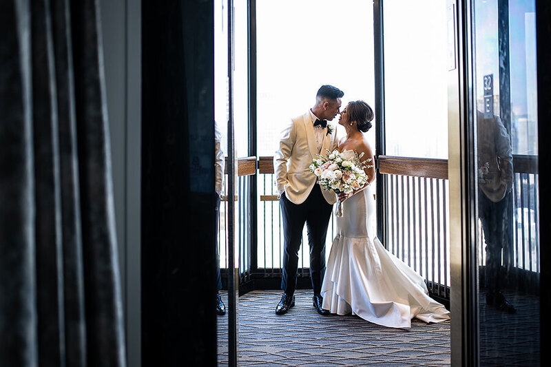 San Francisco wedding photographer documents intimate couple moment in Westin St. Francis glass elevator with natural lighting
