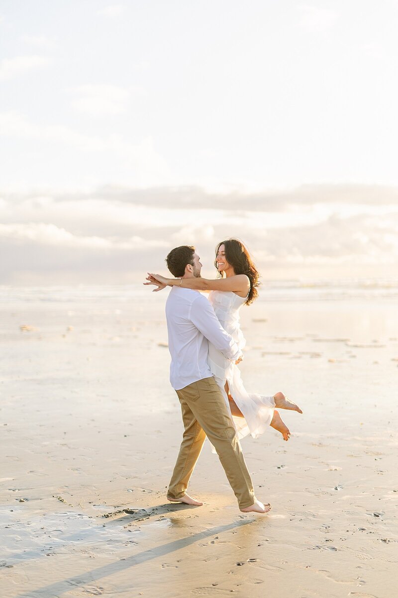Bride and groom spinning around on the beach at Del Mar.
