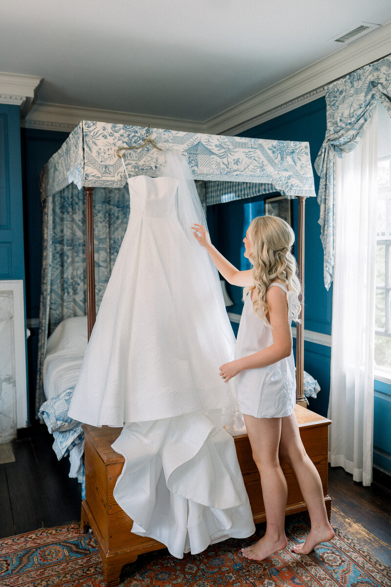 Bride prepping her wedding dress at Historic Tuckahoe for her luxury wedding. Wedding photography taken by Marshall Arts Photography.