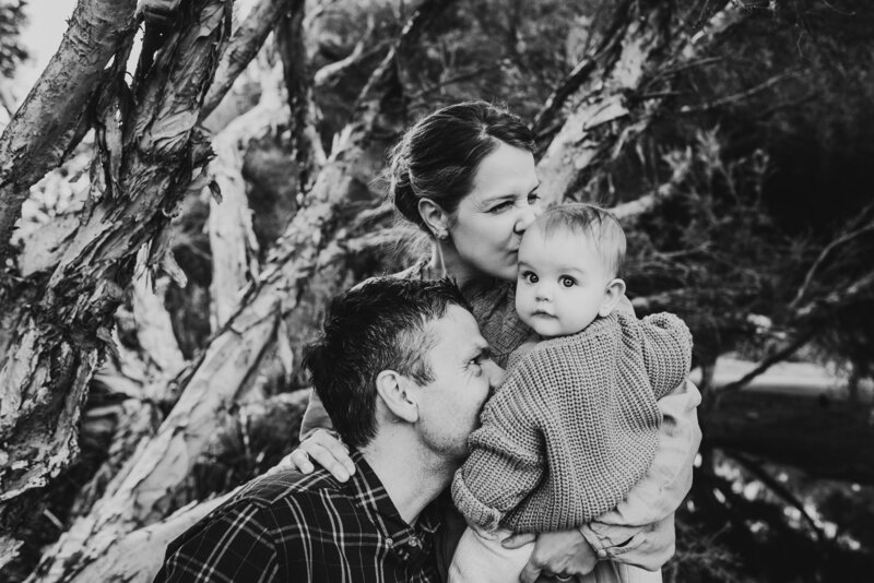 black and white image of dad blowing raspberries on baby's tummy, Family Lifestyle Photographer Fremantle