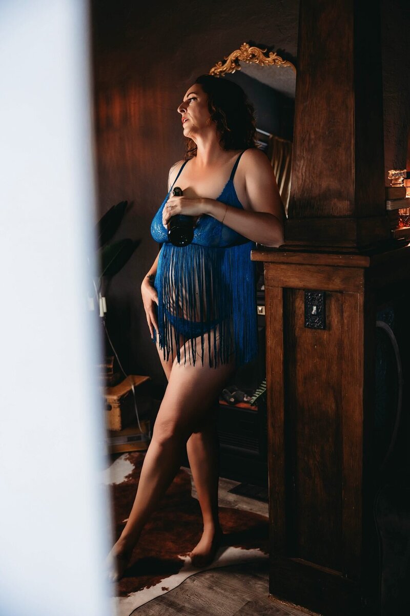 Blue fringe window light boudoir photo by Ivory & Lace Studios in Kingman, Arizona
