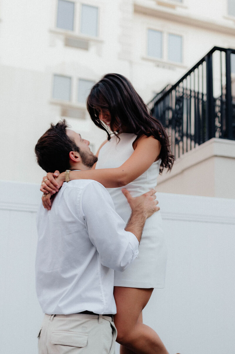 man lifting woman up
