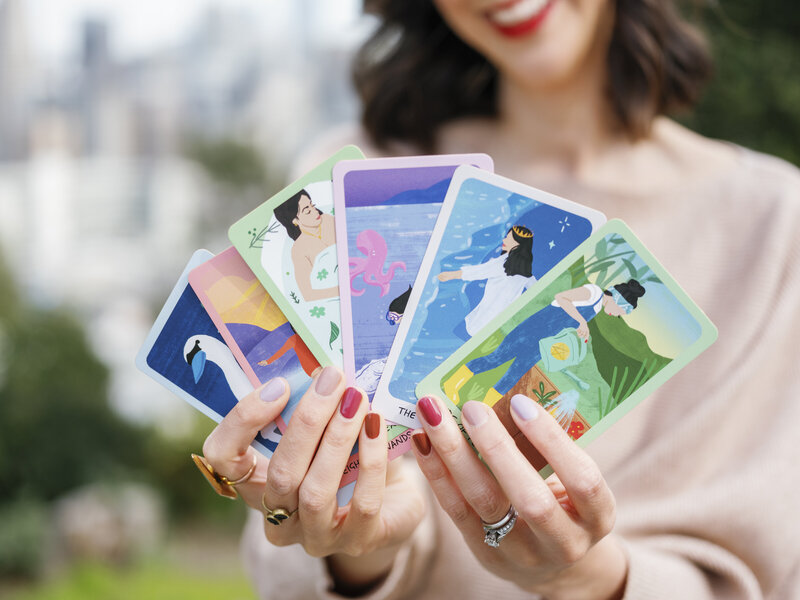 Elizabeth holding tarot cards in hand