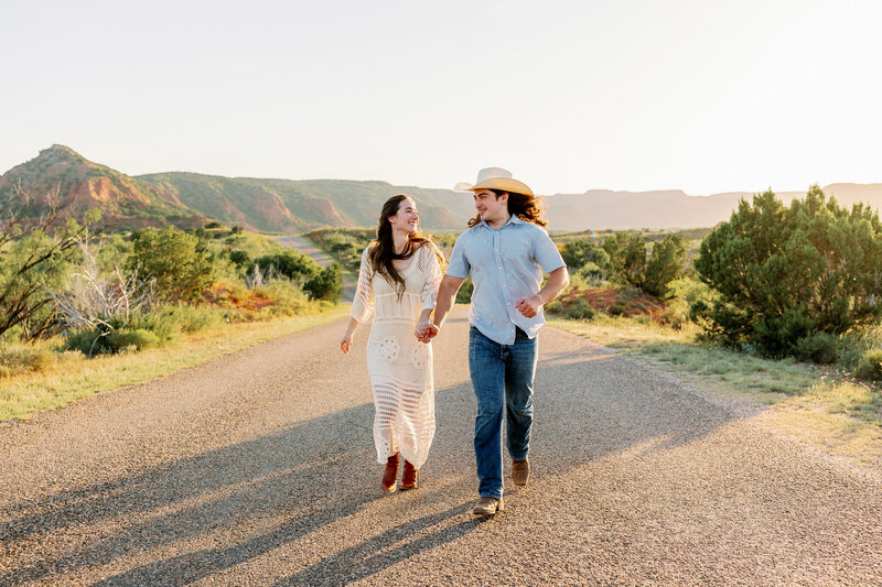 A fun, authentic photograph of a couple running together towards the camera