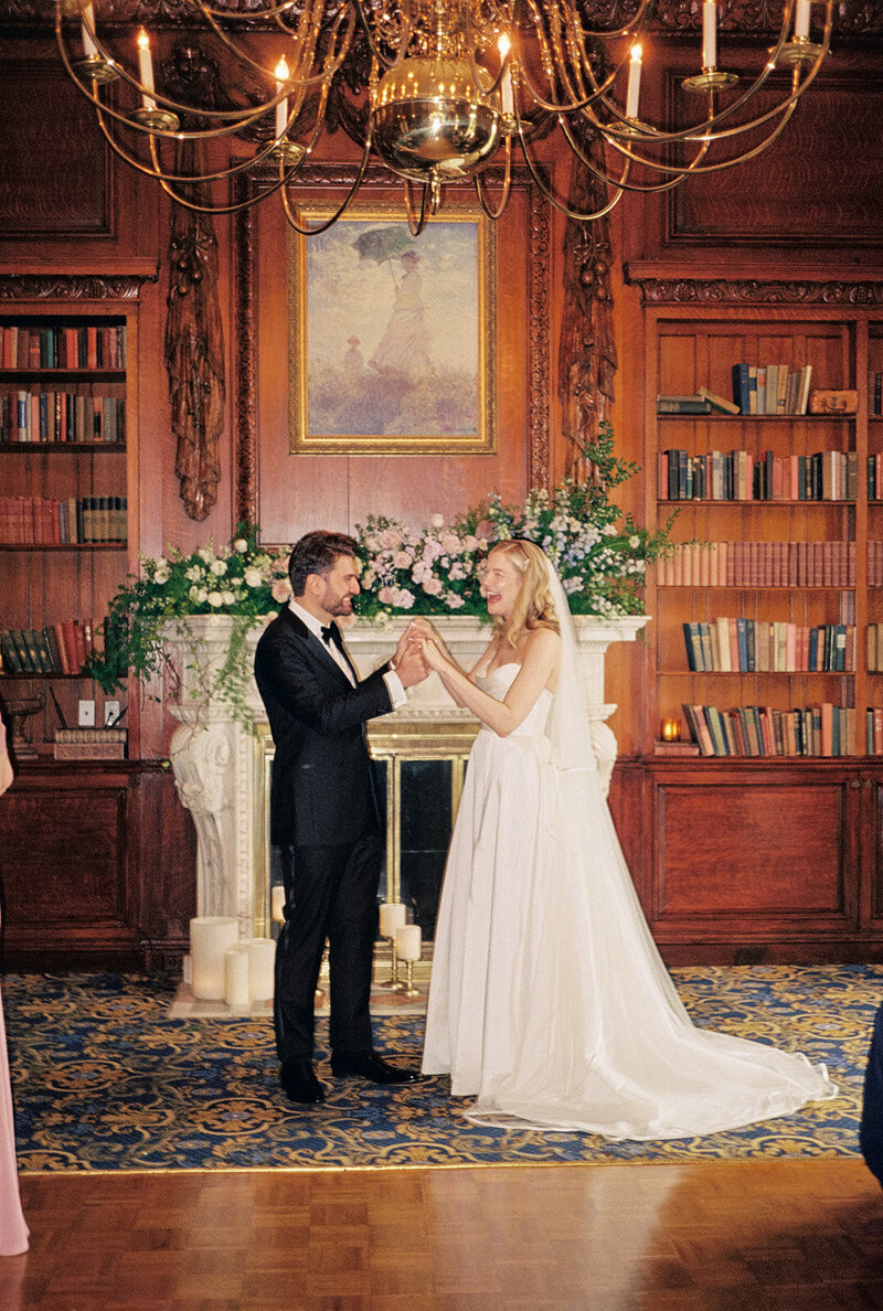 Bride & groom happy inside a library