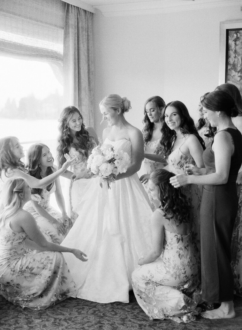 seattle wedding photographers bridesmaids helping bride get dress on at wedding