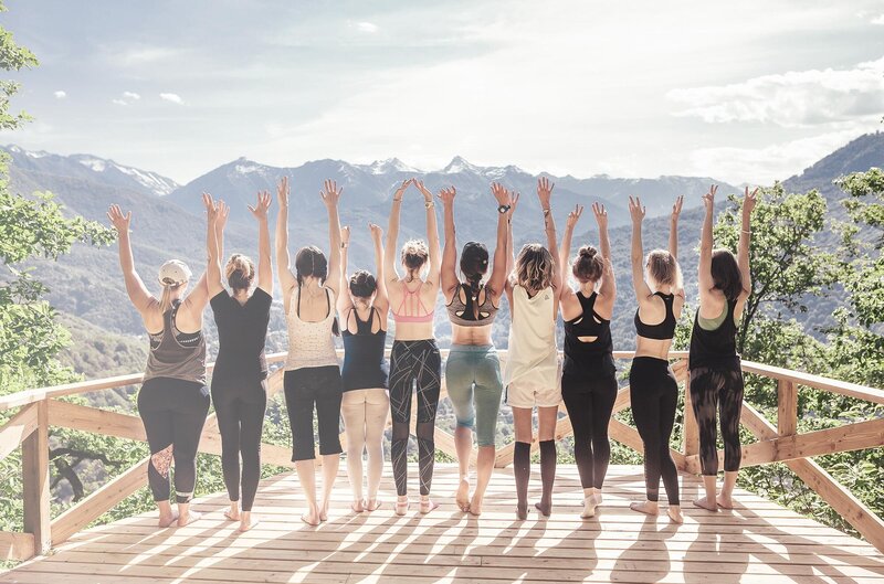 Women with hands in the air in the mountains