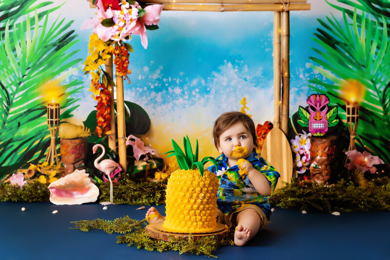Cake Smash Photographer, a baby girl eats cake and sits before balloons