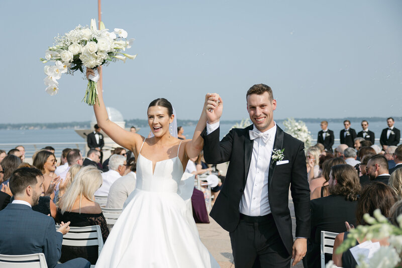 Bride and groom celebrating during their ceremony while being photographed by a Wisconsin wedding photographer.