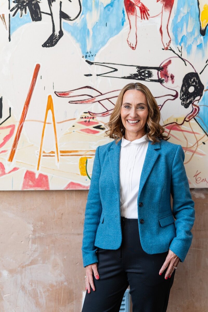 Woman standing in front of bring canvas