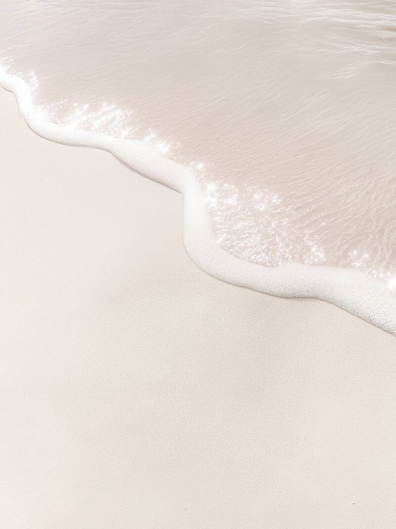 Ocean water shimmers as it meets the shore