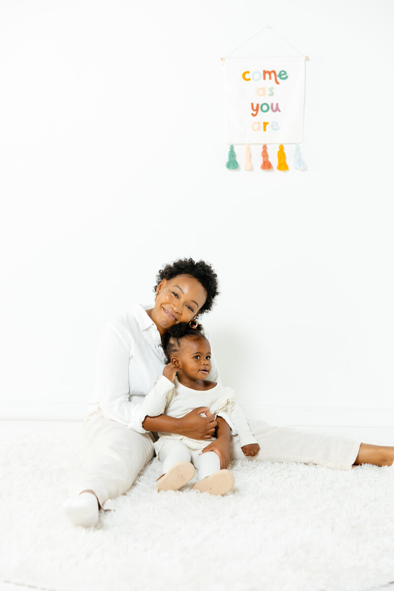 women sitting with toddler on the florr