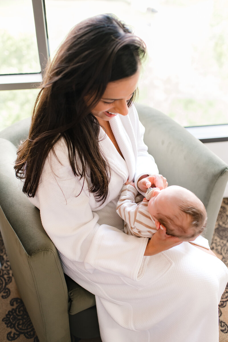 Mother holding newborn at The Ruby Postnatal Retreat in Houston