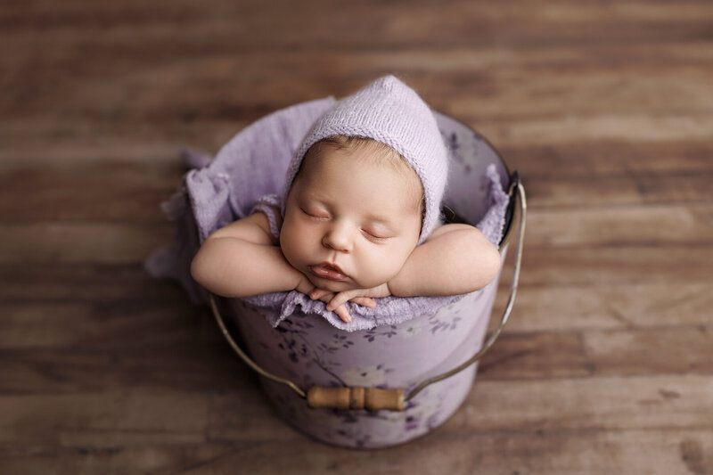 The cutest newborn baby in a purple bucket
