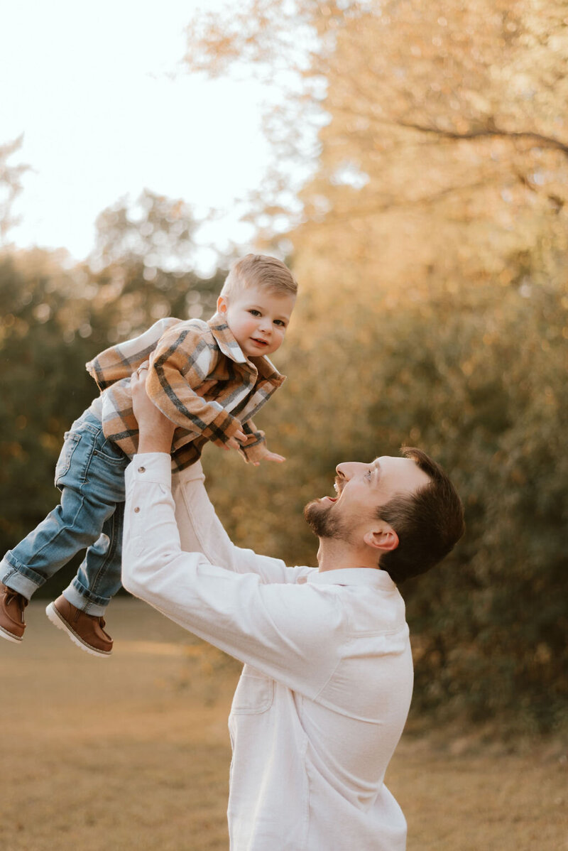 dad holds son during family photos in peoria illinois