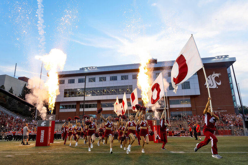 WSU football team run on fireworks