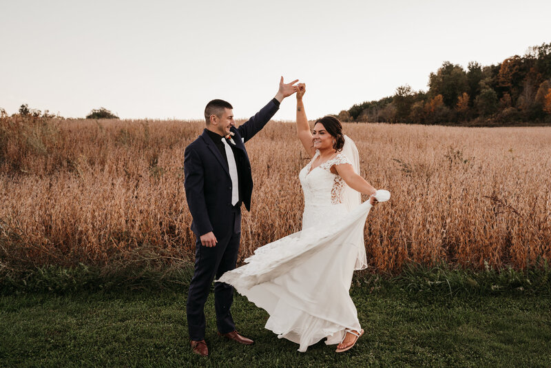 groom twirling his bride at mkj farms