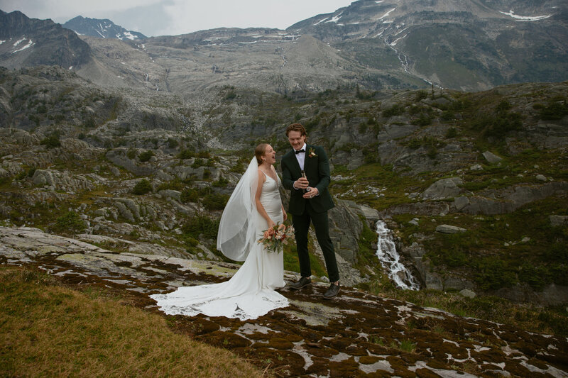 bride and groom surround by smiling bridal party