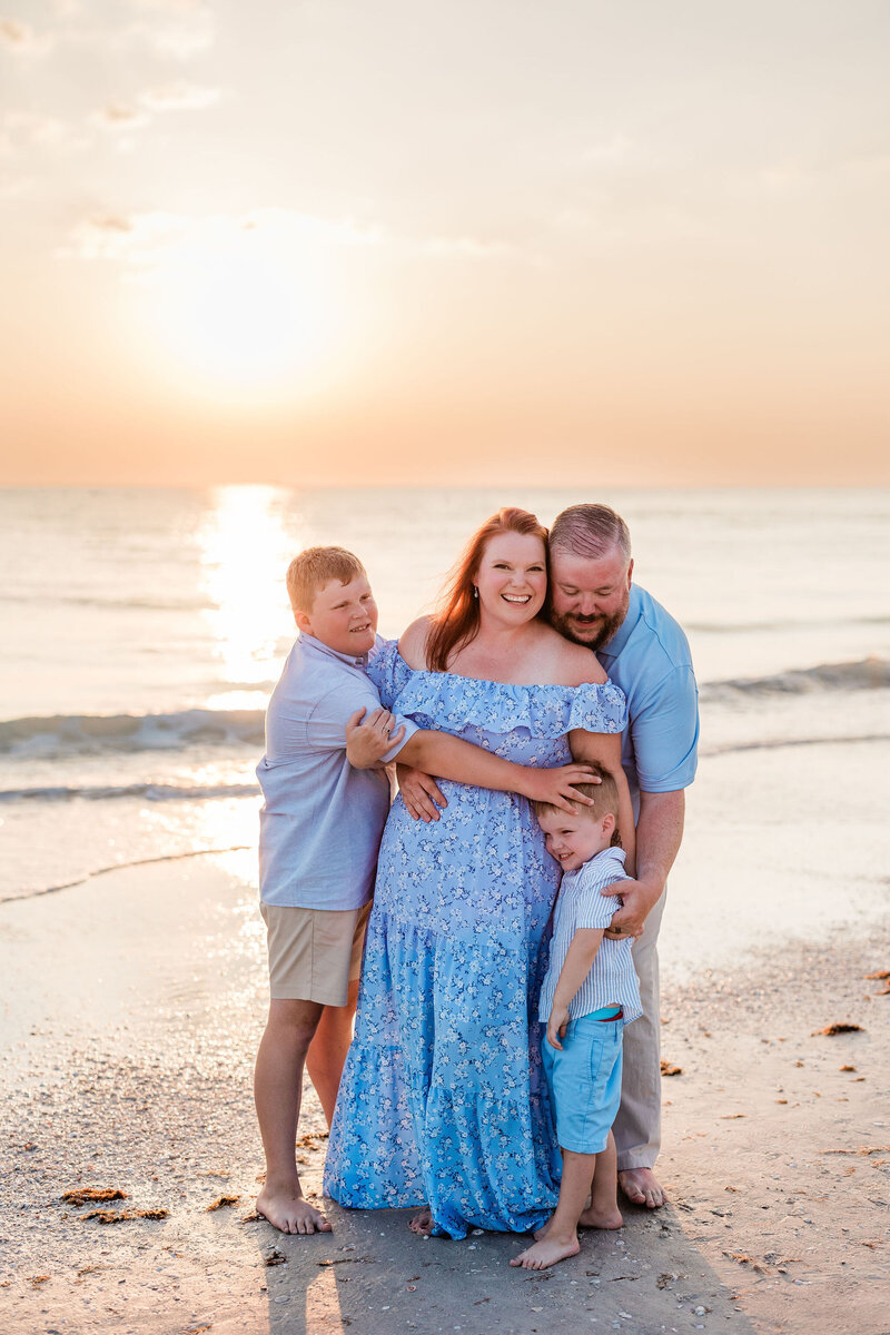 a family smiles at sunset during family photo shoot by St. Pete photographer Apt. B Photography