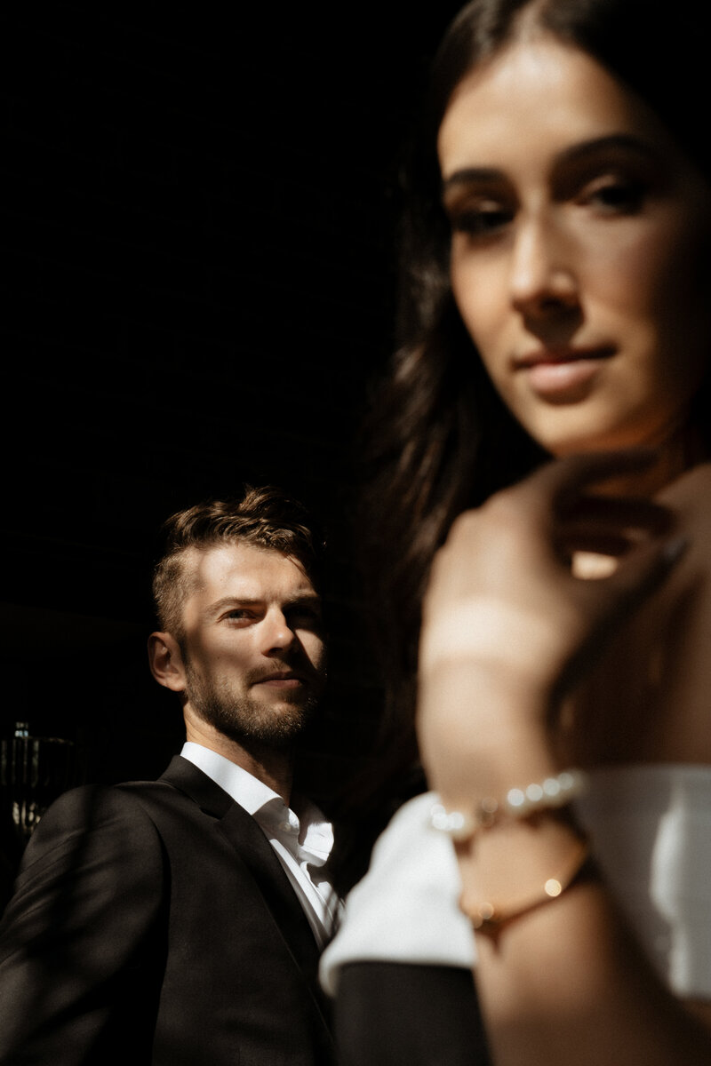 groom looks adoringly at wife in her couture bridal gown toronto hart house ontario