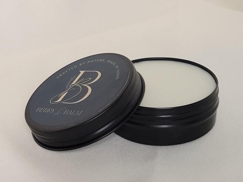 Natural handmade body balm with rosemary, cedar wood, and lemongrass in a tin canister