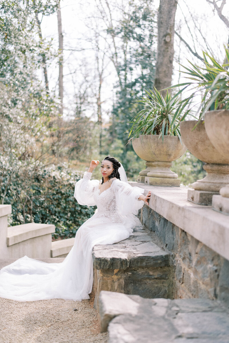 bride sitting on bench at swan house wedding